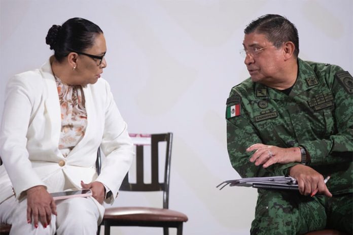 Security Minister Rosa Icela Rodríguez and Defense Minister Luis Cresencio Sandoval confer during the Wednesday morning press conference.