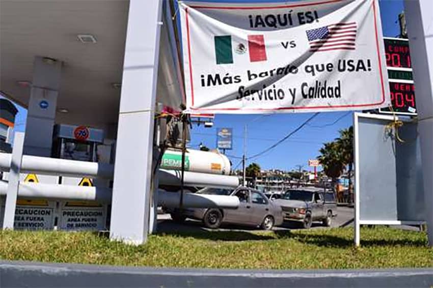 "Here it is! Cheaper than USA," reads an advertisement at a Tijuana gas station.