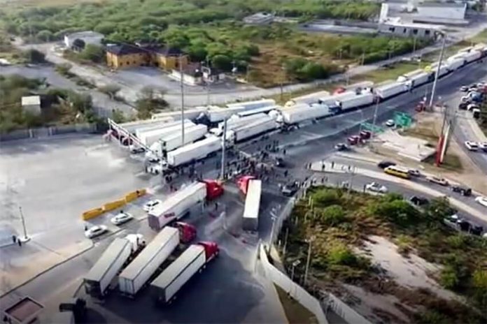Truckers blocked the Pharr-Reynosa International Bridge on Monday to protest Texas' slow, thorough new inspection policy.