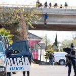 A body hangs from an overpass