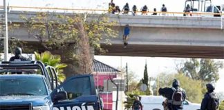 A body hangs from an overpass