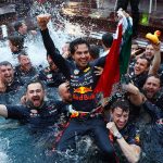 Checo Pérez celebrates his win with the Red Bull team.