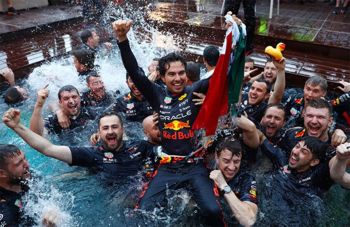 Checo Pérez celebrates his win with the Red Bull team.