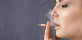 woman smokes cigarette