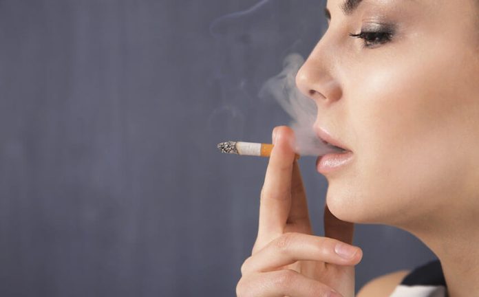 woman smokes cigarette