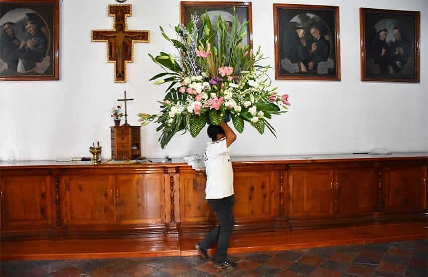 boy preps flower for Fiesta Floracultores, Cholula, Puebla