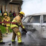 firemen putting out car fire in San Cristobal de Las Casas