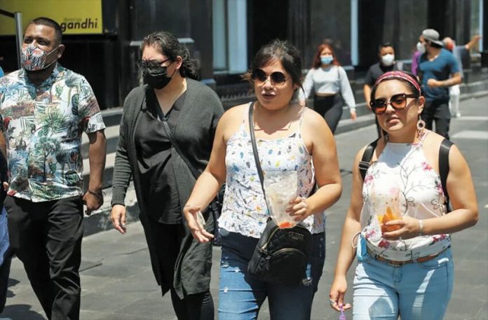 Pedestrians with and without face masks in Mexico City.