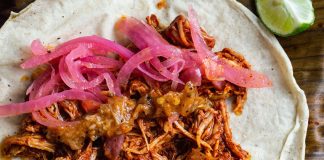 A taco made with cochinita pibil.