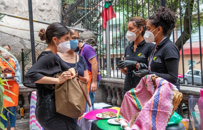 Shoppers and vendors wearing face masks at a market in Mexico City