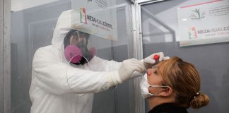 A health worker performs a COVID-19 test in Nezahualcóyotl