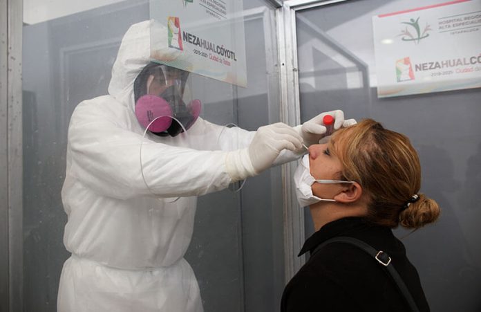 A health worker performs a COVID-19 test in Nezahualcóyotl