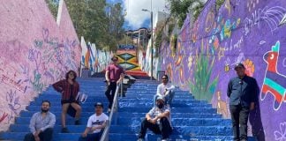 Participating artists pose on the stairs up Remedios Hill.