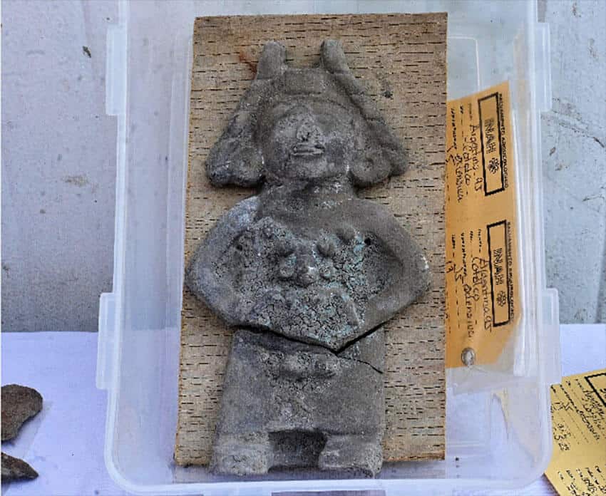 One of the children was buried with a figurine of a woman holding a young girl.