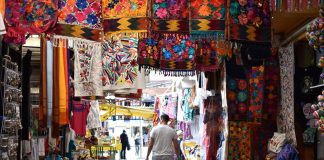 A tourist explores a Mexico City textile market.