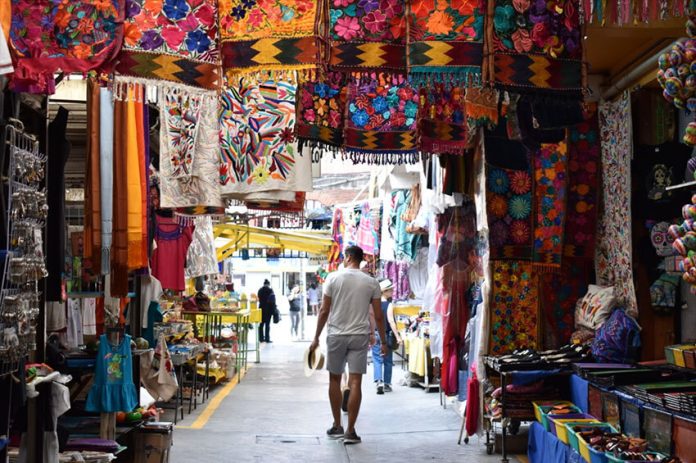 A tourist explores a Mexico City textile market.
