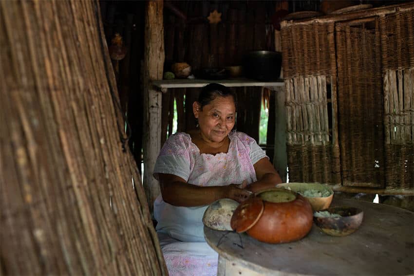 During tours of the community, Cecilia's mother Aurelia Cahum Balam shows visitors how she makes traditional Maya meals with fresh ingredients from the farm. 