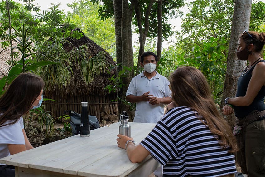 Cecilia's brother Efrain Cahum explains the rural lifestyle of the community to a group of tourists from France soon after the reopening of the community for ecotourism.