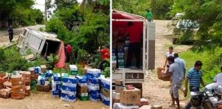 Local residents help recover goods that spilled from a truck after an accident.