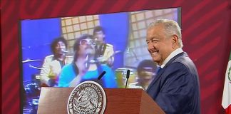 The president chuckles as he plays the song "Uy, qué miedo," by Chico Che y La Crisis, at Wednesday's news conference.