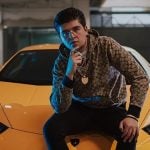 Fofo Márquez poses with a luxury sportscar.