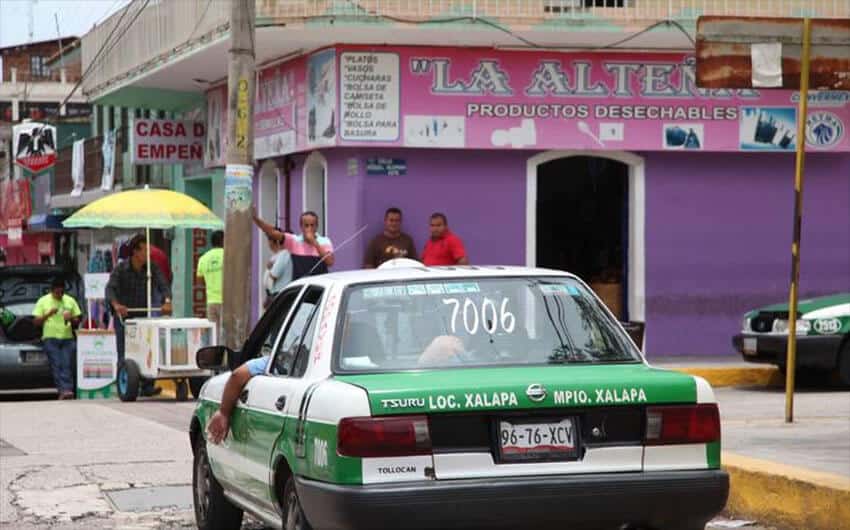 A Xalapa taxi waits at a corner.