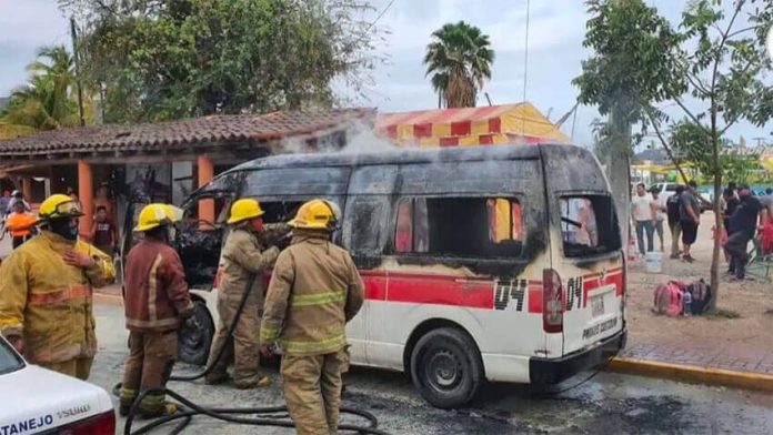 Firefighters extinguish a blaze in a public transit vehicle in Zihuatanejo