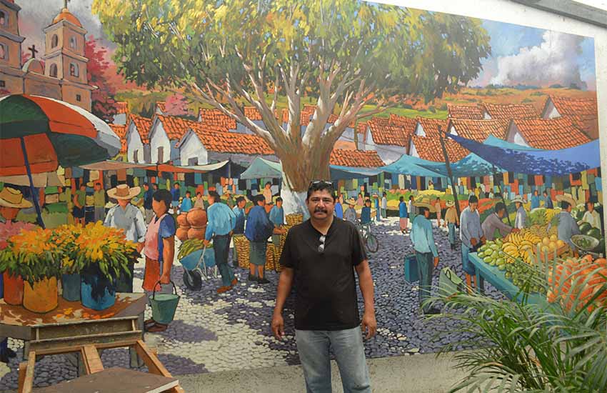 mural in Ajijic by Efren Gonzalez with artist in front