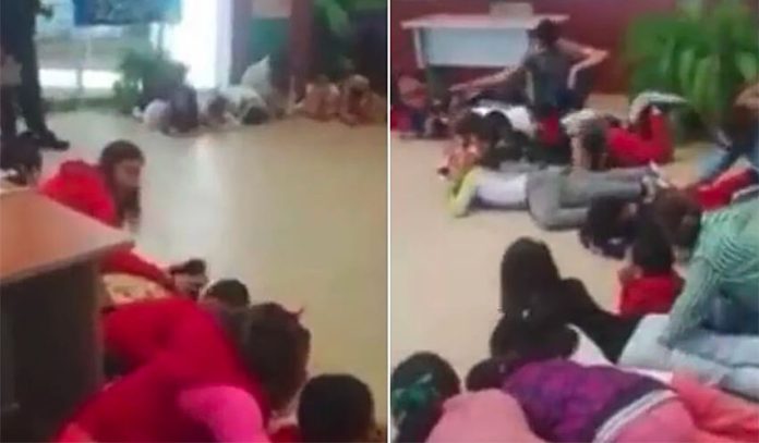 Students take cover on the floor during mock gunbattle