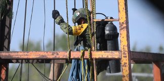 An army diver descends into the mine.