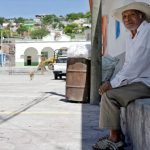 A man sits in the central plaza of Xoyatla, Puebla.