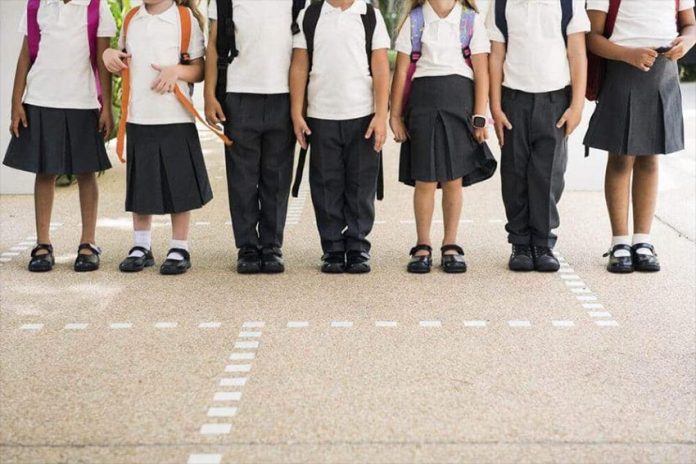 Students in school uniform pants and skirts.
