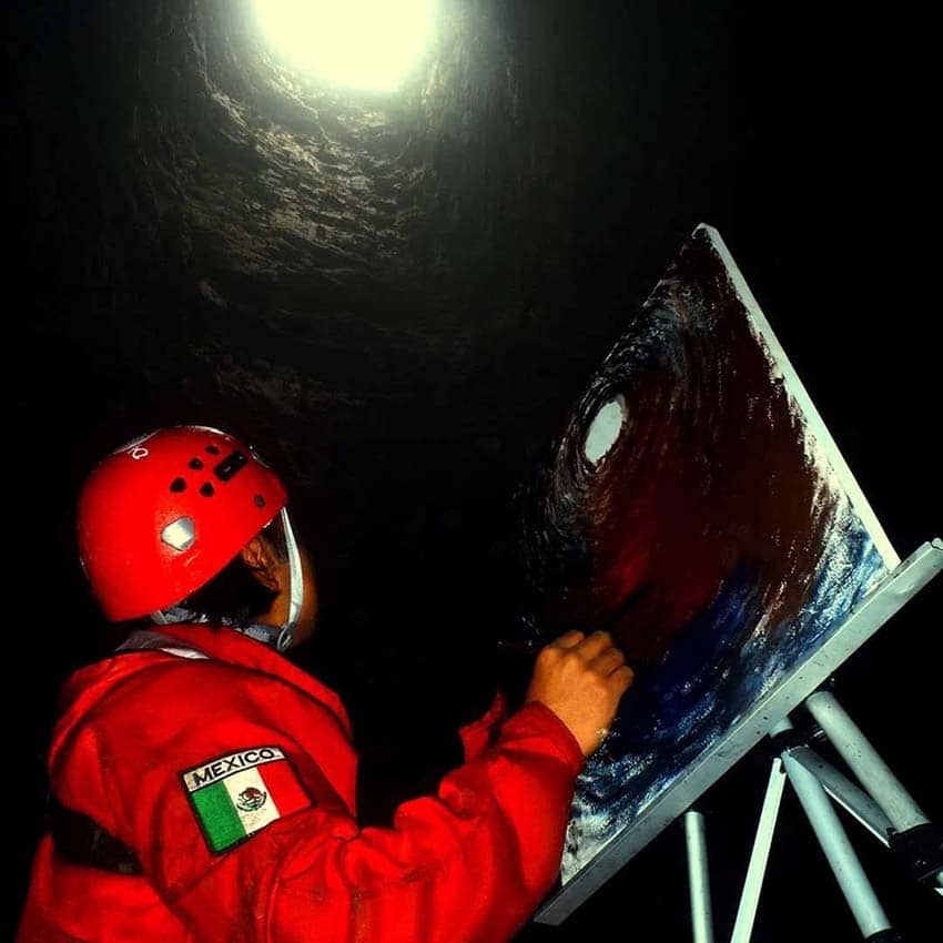 Artist Victor Cruz doing a painting of Mexico's Golondrinas Cave