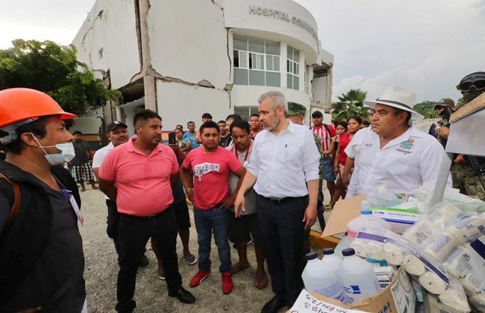 Governor of Michoacan touring earthquake damage in Aquila, Michoacan