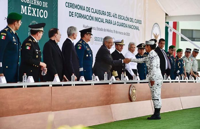AMLO shaking hand of new National Guard member in 2020