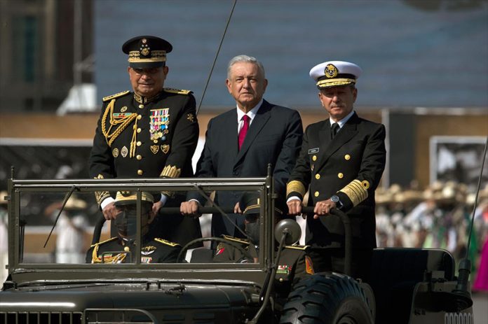 President López Obrador celebrates the start of the Mexican Revolution in a 2021 military parade, accompanied by Army Minister Luis Cresencio Sandoval and Navy Minister José Rafael Ojeda Durán.