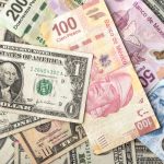 Pesos and dollar bills mixed together.