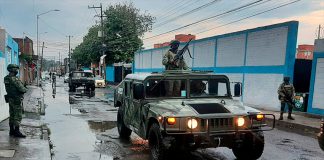 A military regiment patrols the streets in Puebla after heavy rains.