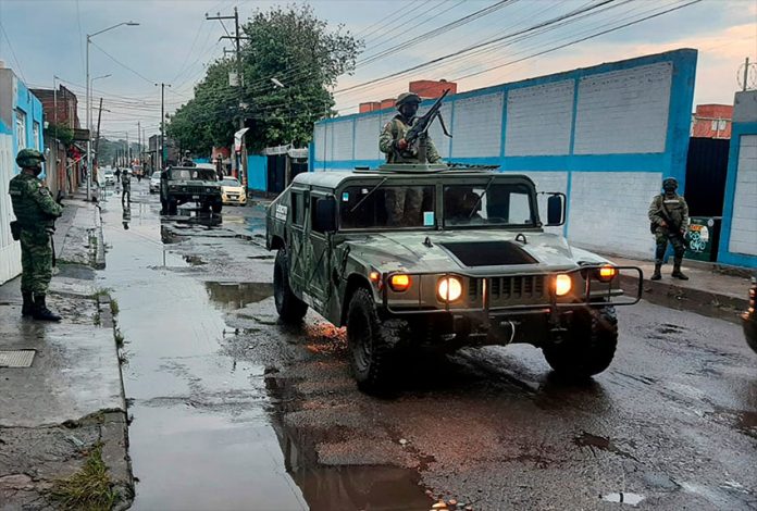 A military regiment patrols the streets in Puebla after heavy rains.