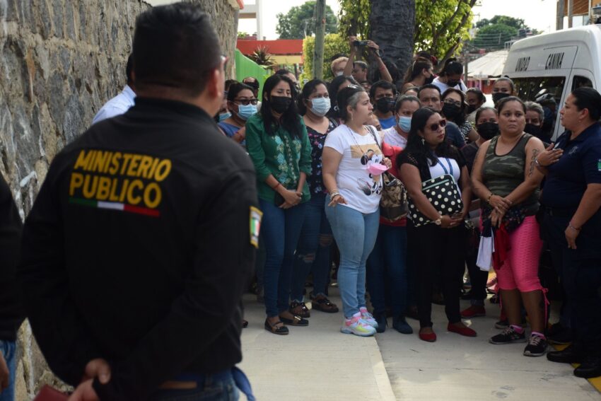 parents wait outside Federal No. 1 school in Tapachula, Chiapas for information about mass poisonings of students