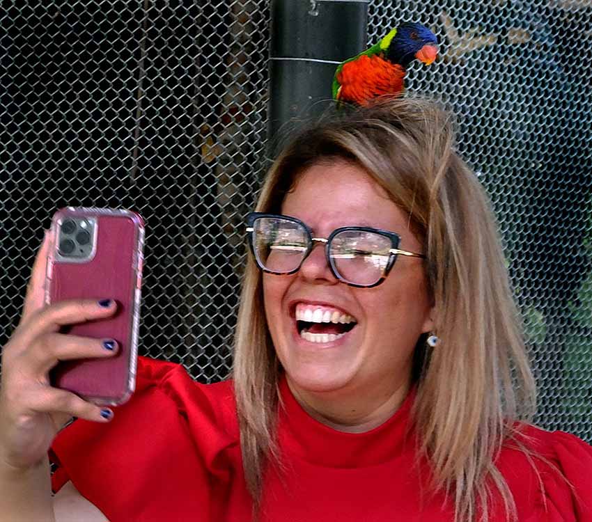 guests with a coconut lorikeet at aviary of Guadaljara Zoo