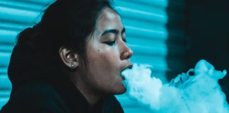 Mexican woman vaping on the street