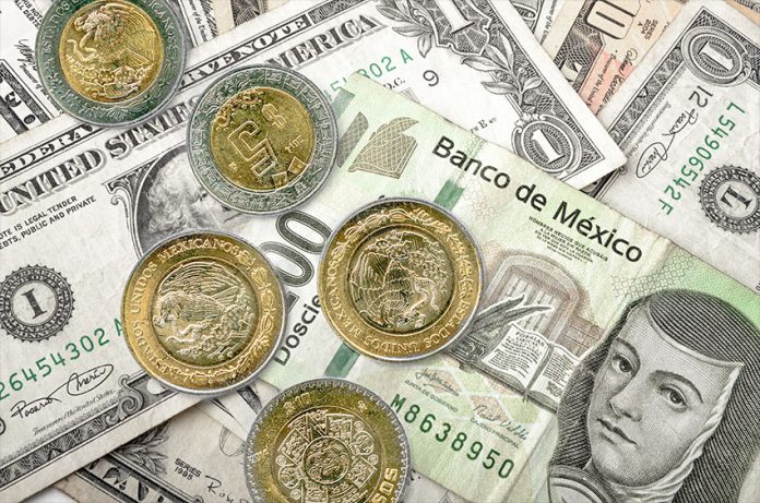 U.S. dollar bills with Mexican peso bills and coins.