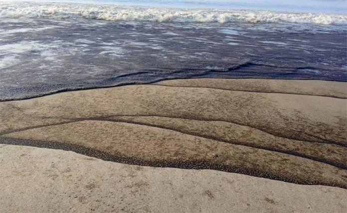 Local residents reported beaches streaked with oil and a foul smell along the coast.