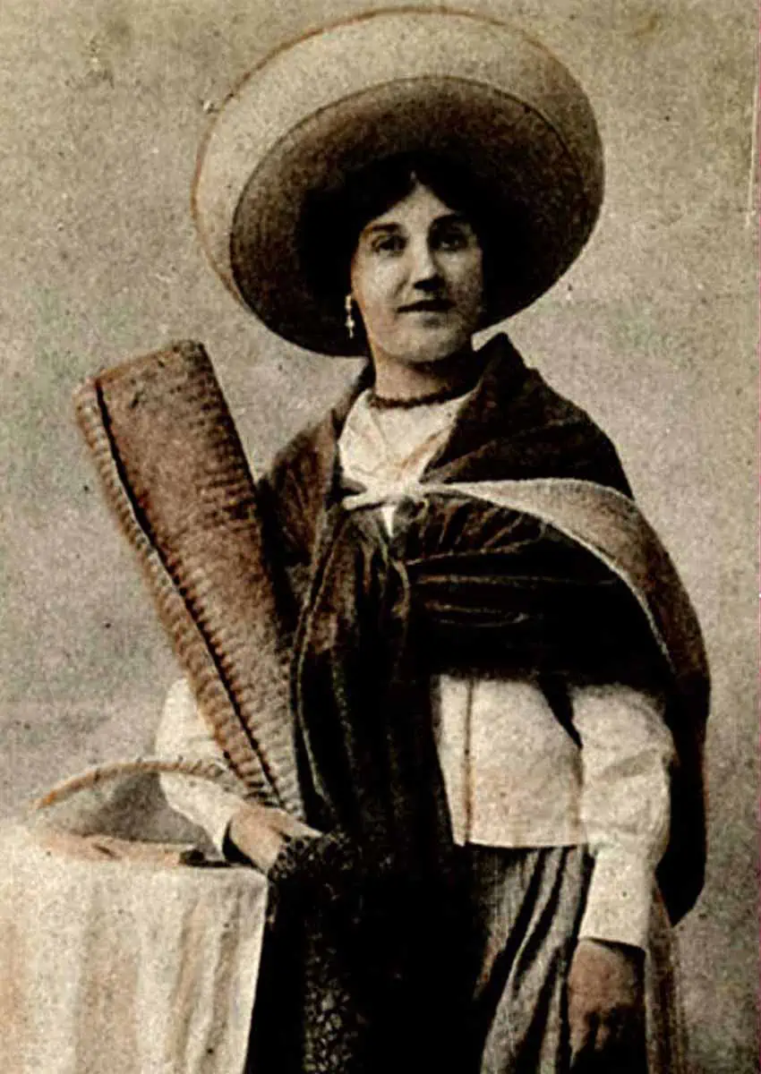 woman holding a petate mat