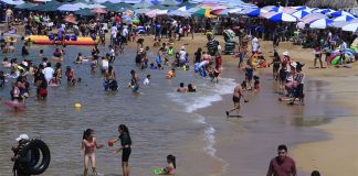 Tourists enjoy the beach in Acapulco, in July of this year.