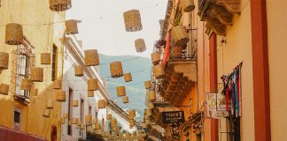 A view down a narrow, brightly painted street in Guanajuato.