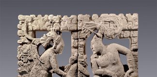 A lord and his companion observe a small supernatural creature seated between them in this intricately carved backrest for a throne.