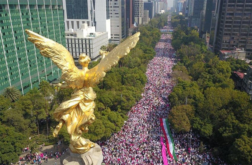 The crowd, many wearing the pink and white colors of the INE logo, filled Mexico City's Paseo de la Reforma on Sunday.