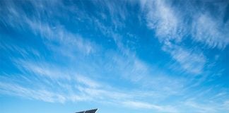A solar farm on a mostly clear day.